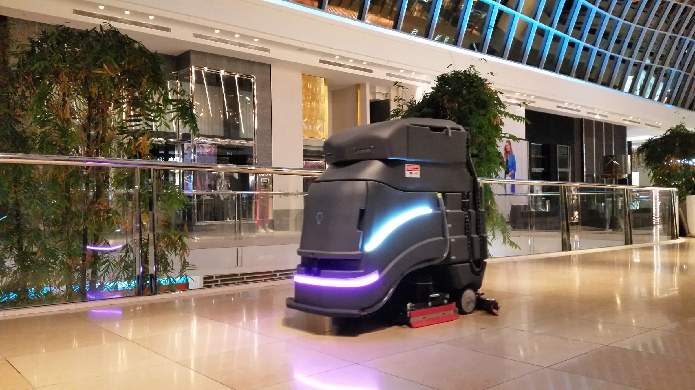 Avidbots Neo autonomous floor scrubber cleaning a shopping center
