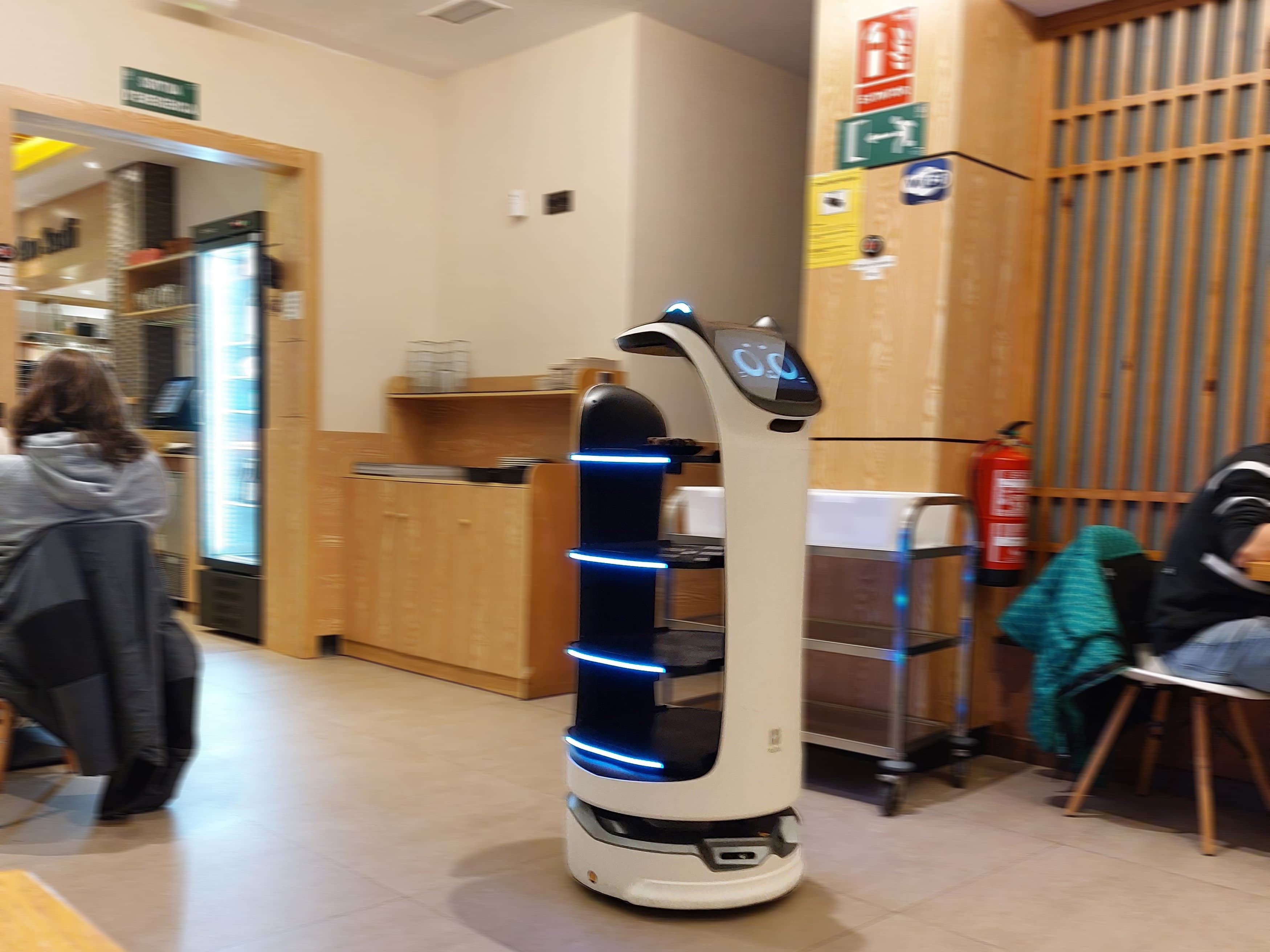 Pudu BellaBot service robot delivering food in a restaurant