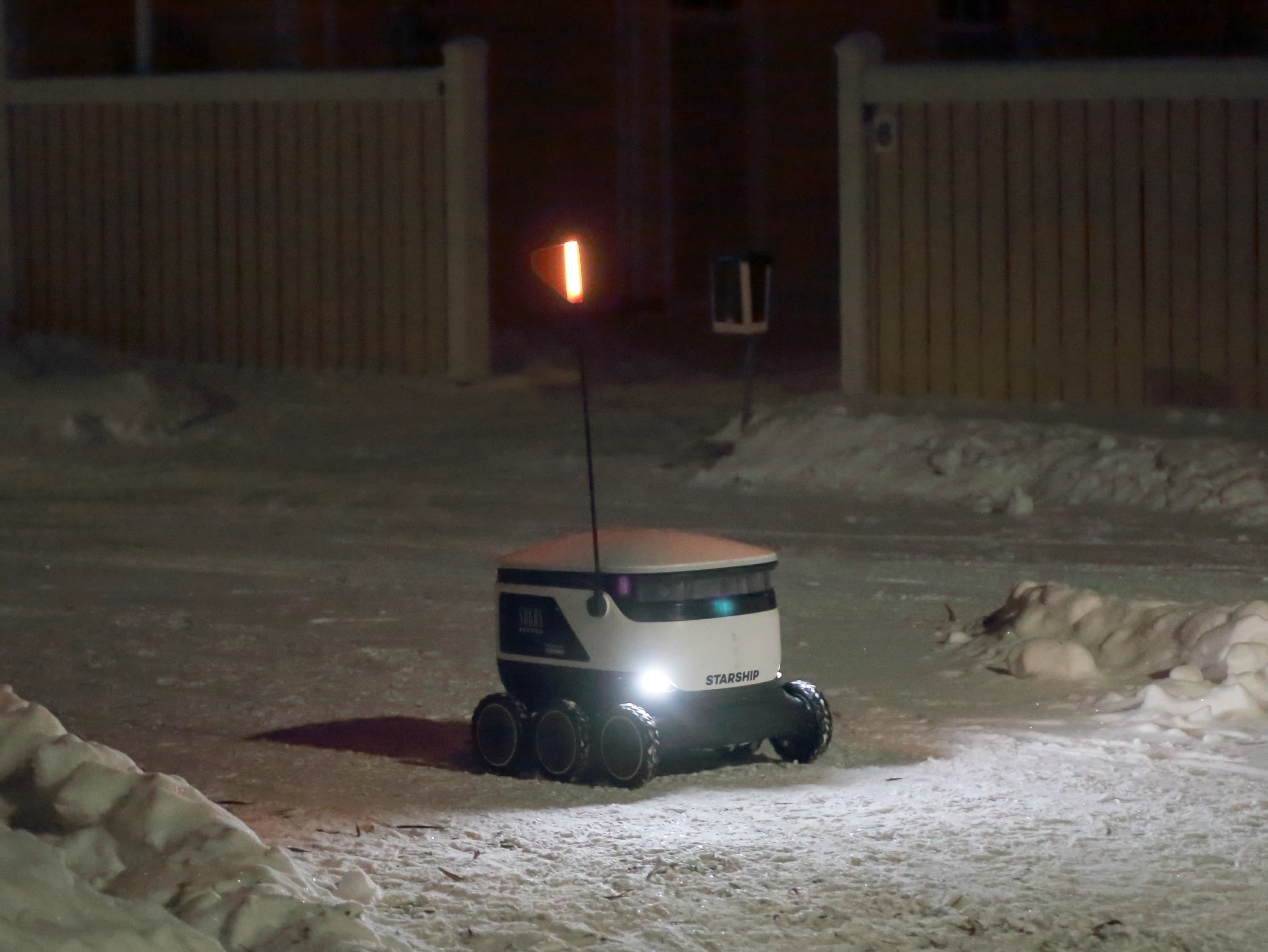 Starship autonomous delivery robot operating on a street in Finland